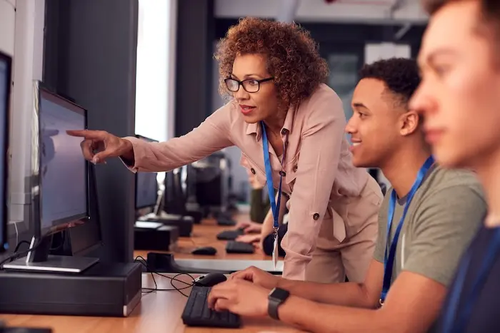 Two young men in a computer lab participating in an autism job training program.
