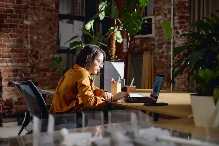 Young woman on her laptop applying to technology jobs for adults with autism