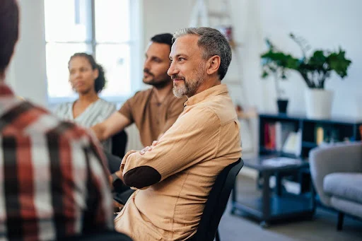 Middle aged man at a support group meeting for parents of autistic adults.